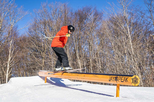 Person skiing on a rail at one of Jay Peak Resort's terrain parks.