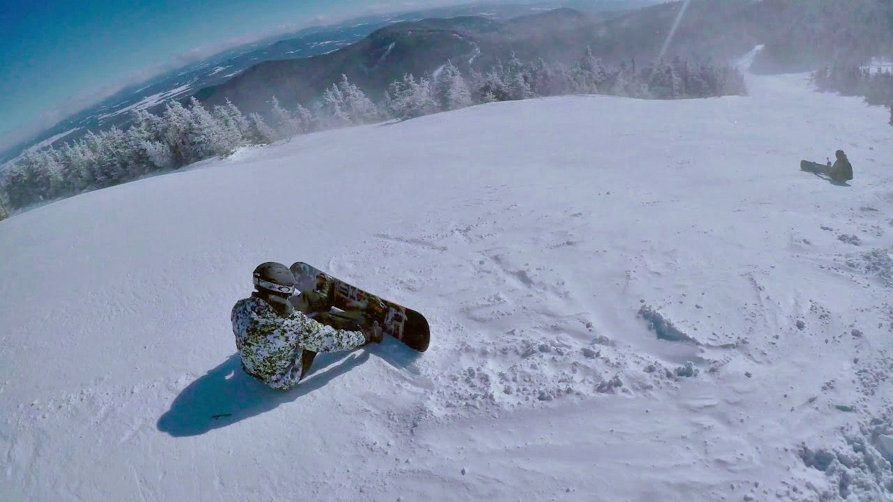 Load video: Snowboarder on mountain. Ski the Peak Tours promo video.