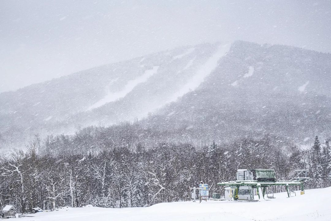 Vermont's Jay Peak mountain in the distance. Snowy weather and trees covered in snow.